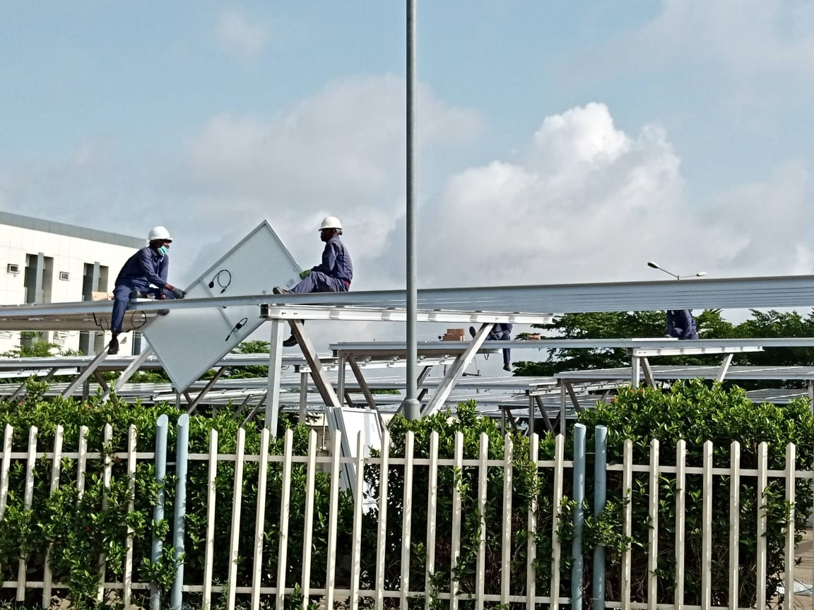 Riggers setting a canopy purlin