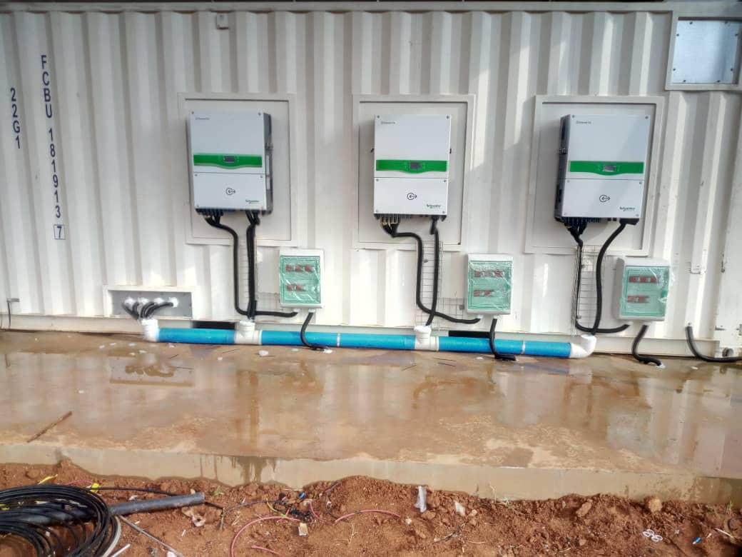 String inverters mounted to a container wall